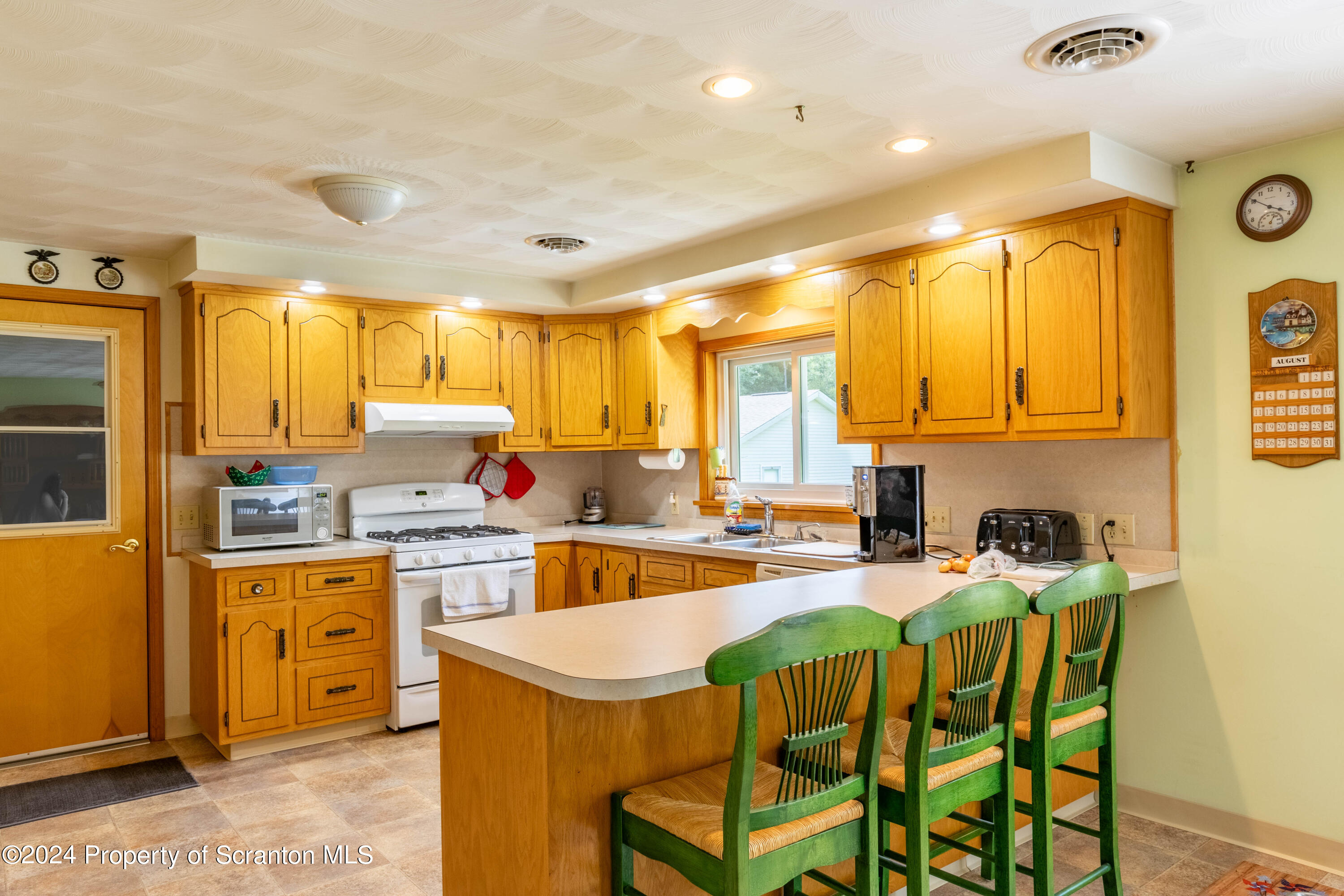 6509 State Rte 2012 Union Dale, PA 18470 - Photo 60 of 91 a kitchen filled counter top space a sink appliances and cabinets