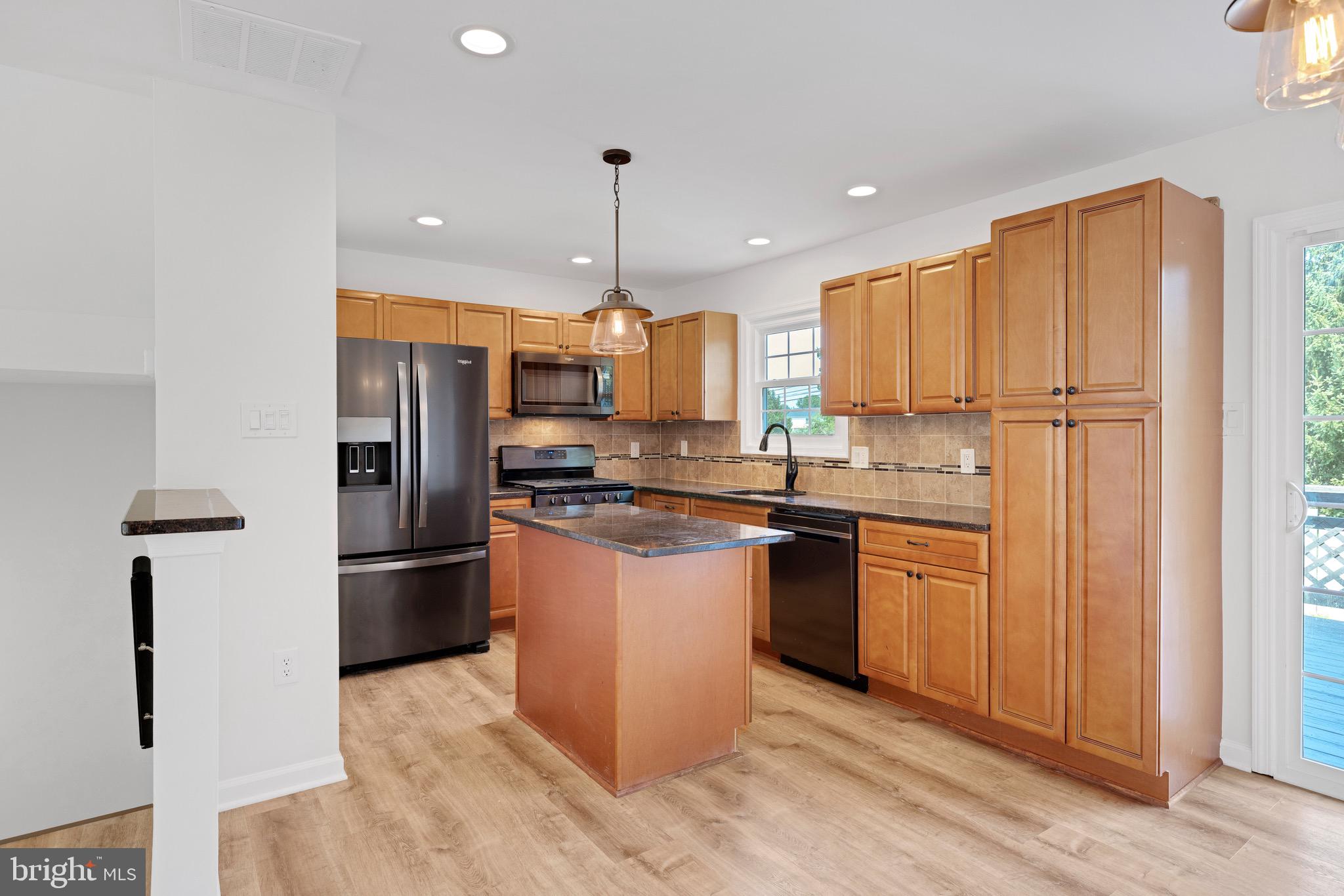 8 Versailles Court Newark, DE 19702 - Photo 13 of 30 a kitchen with stainless steel appliances granite countertop a refrigerator a sink and a stove