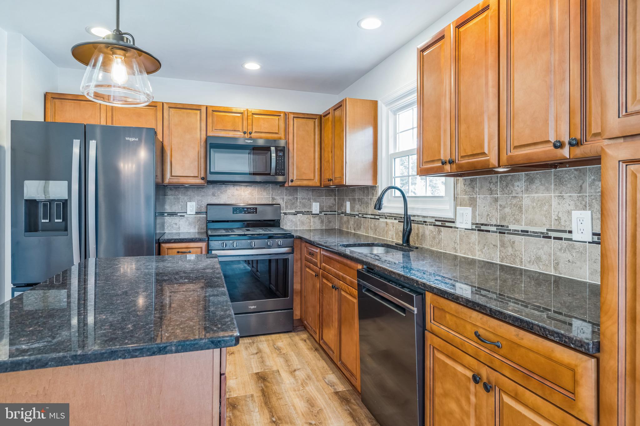 8 Versailles Court Newark, DE 19702 - Photo 16 of 30 a kitchen with stainless steel appliances granite countertop a sink a stove and a refrigerator