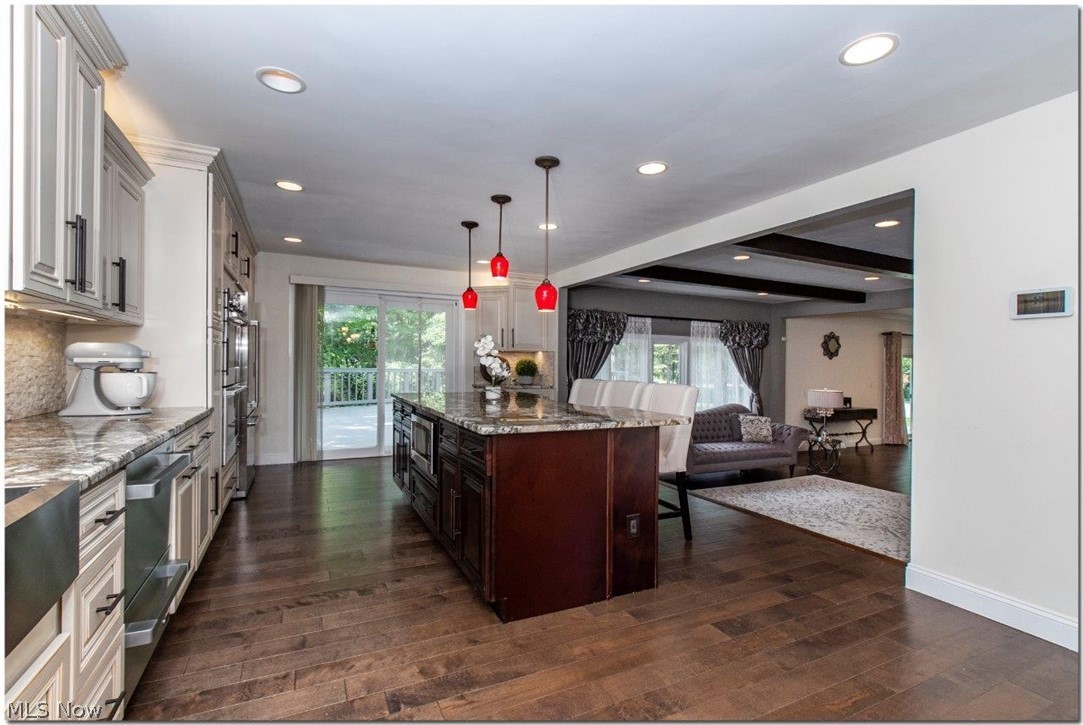 3200 Lander Road Pepper Pike, OH 44124 - Photo 12 of 35 The gourmet kitchen comes equipped with an abundance of cabinet space, center island, and high-end stainless steel appliances including a counter top range and double ovens.
Sliders allow access to a sizable back deck