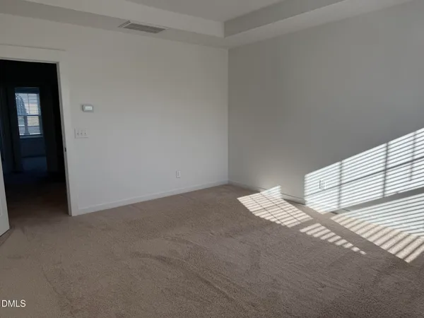 a view of an empty room and a windows