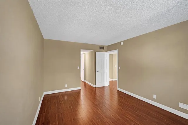 a view of a room with wooden floor and window
