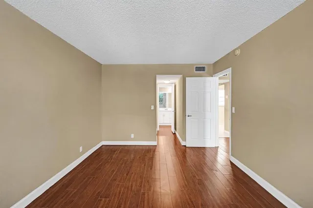 a view of a room with wooden floor