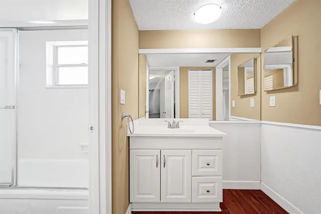 a white toilet sitting next to a bath tub