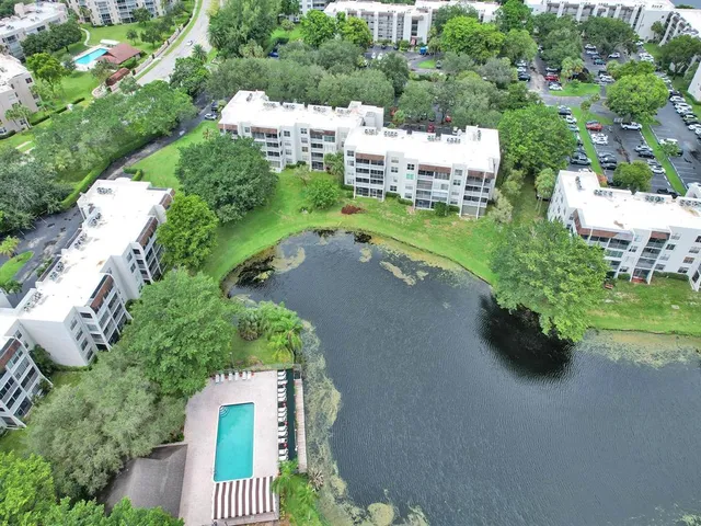 an aerial view of a house with yard swimming pool and outdoor seating