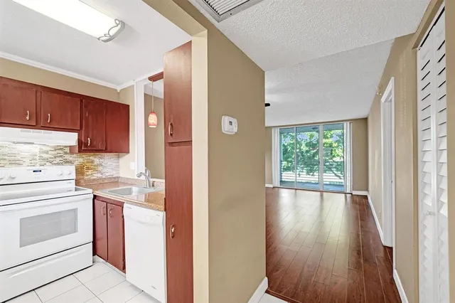 a kitchen with a stove top oven sink and cabinets