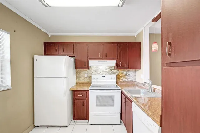 a kitchen with a white stove top oven and refrigerator