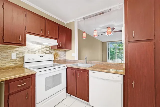 a kitchen with a sink stove and cabinets