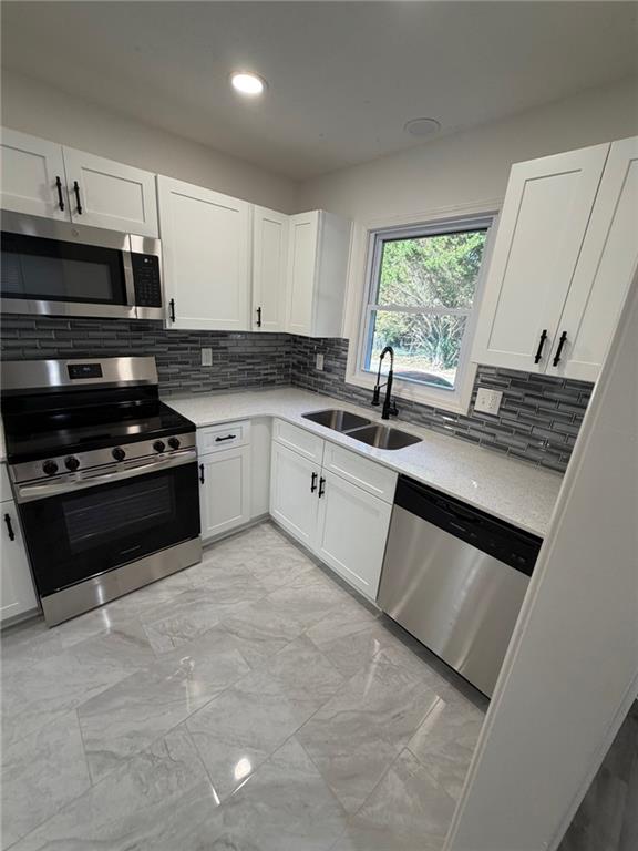 2250 Kings Gate Circle Southwest, Unit B Snellville, GA 30078 - Photo 1 of 31 a kitchen with stainless steel appliances granite countertop a stove a sink and a microwave
