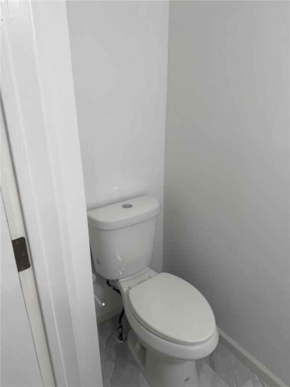 2250 Kings Gate Circle Southwest, Unit B Snellville, GA 30078 - Photo 12 of 31 a white toilet sitting next to a white cabinet