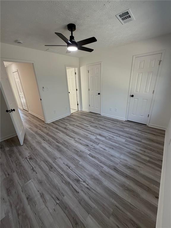 2250 Kings Gate Circle Southwest, Unit B Snellville, GA 30078 - Photo 20 of 31 a view of empty room with wooden floor and fan