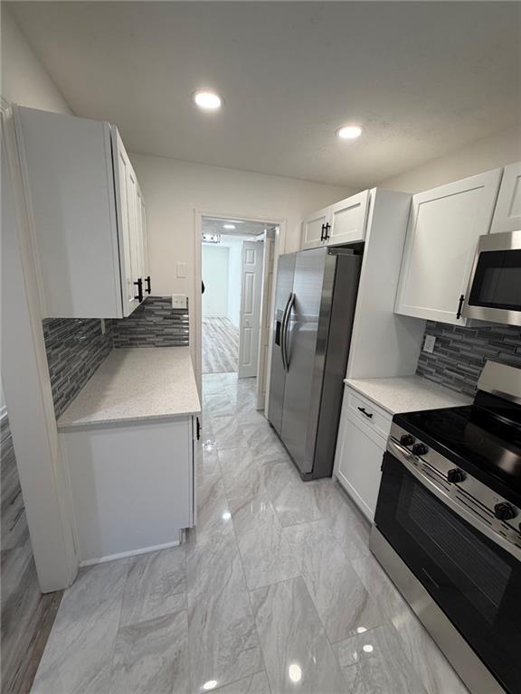 2250 Kings Gate Circle Southwest, Unit B Snellville, GA 30078 - Photo 6 of 31 a kitchen with stainless steel appliances a refrigerator stove and sink