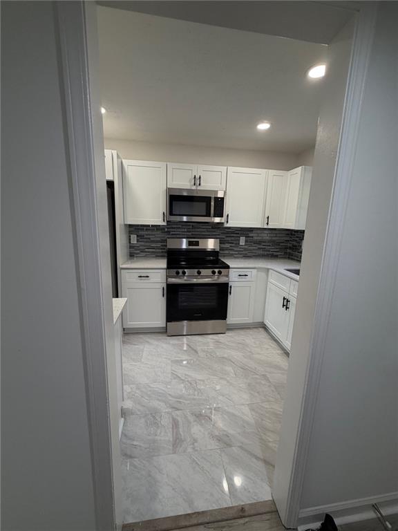 2250 Kings Gate Circle Southwest, Unit B Snellville, GA 30078 - Photo 8 of 31 a kitchen with a sink and white cabinets
