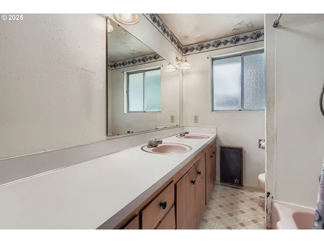 a bathroom with a sink vanity and mirror