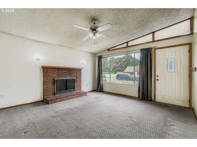 a view of an empty room with a fireplace
