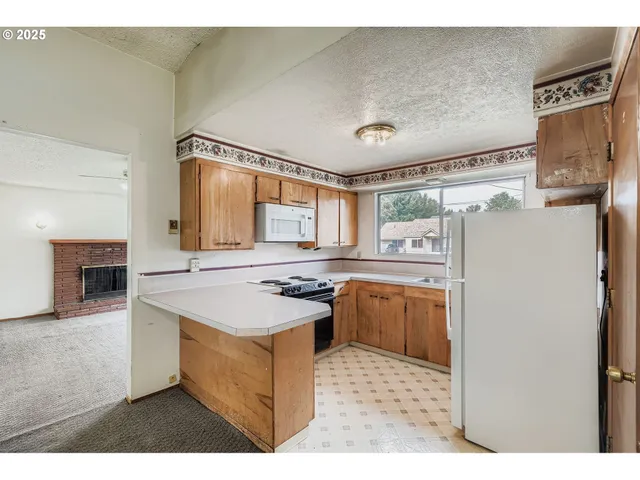 a kitchen with a refrigerator and a stove