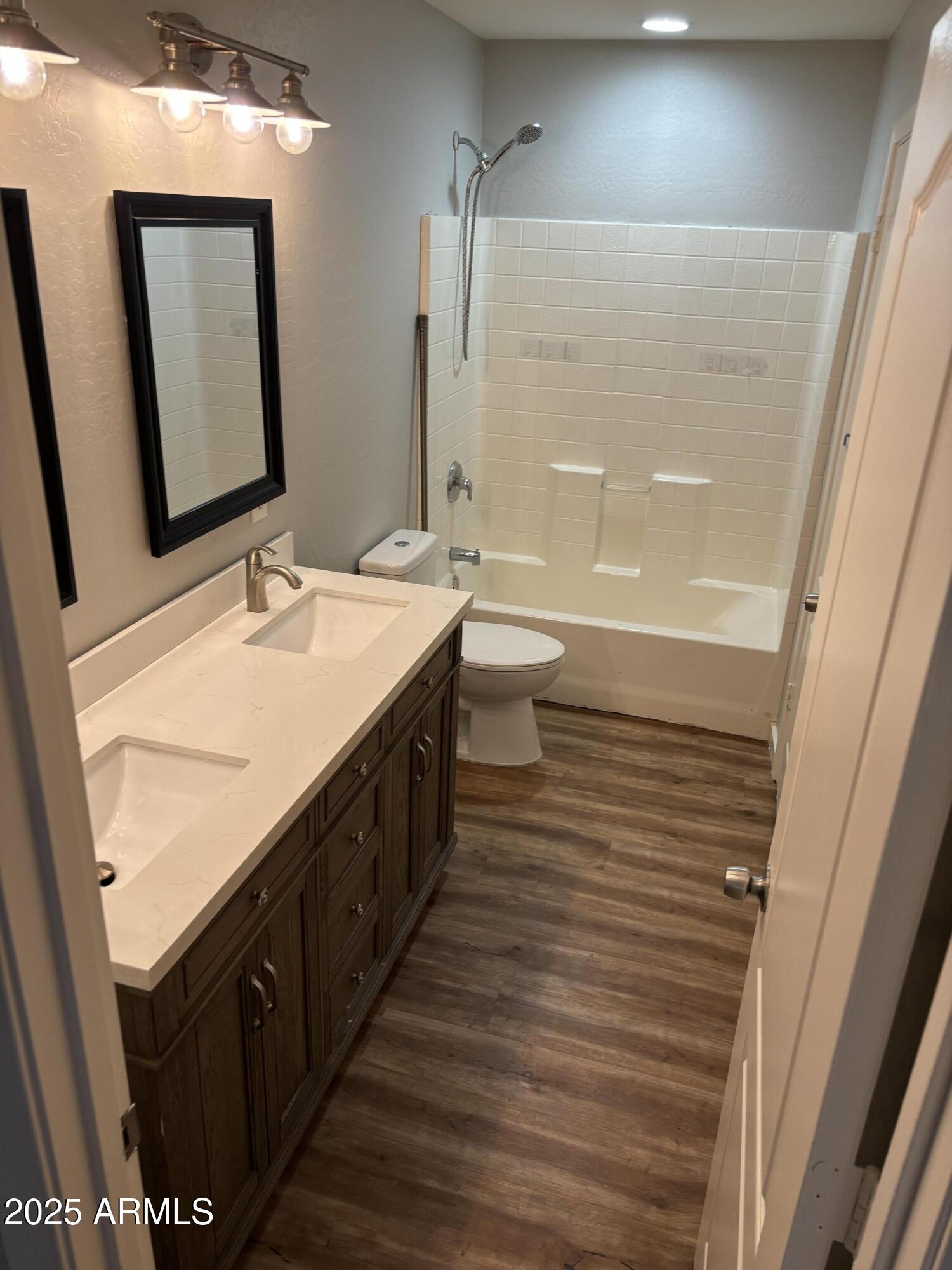 528 East Navajo Avenue, Unit 3 Apache Junction, AZ 85119 - Photo 14 of 14 a spacious bathroom with a double vanity sink a mirror and a bathtub