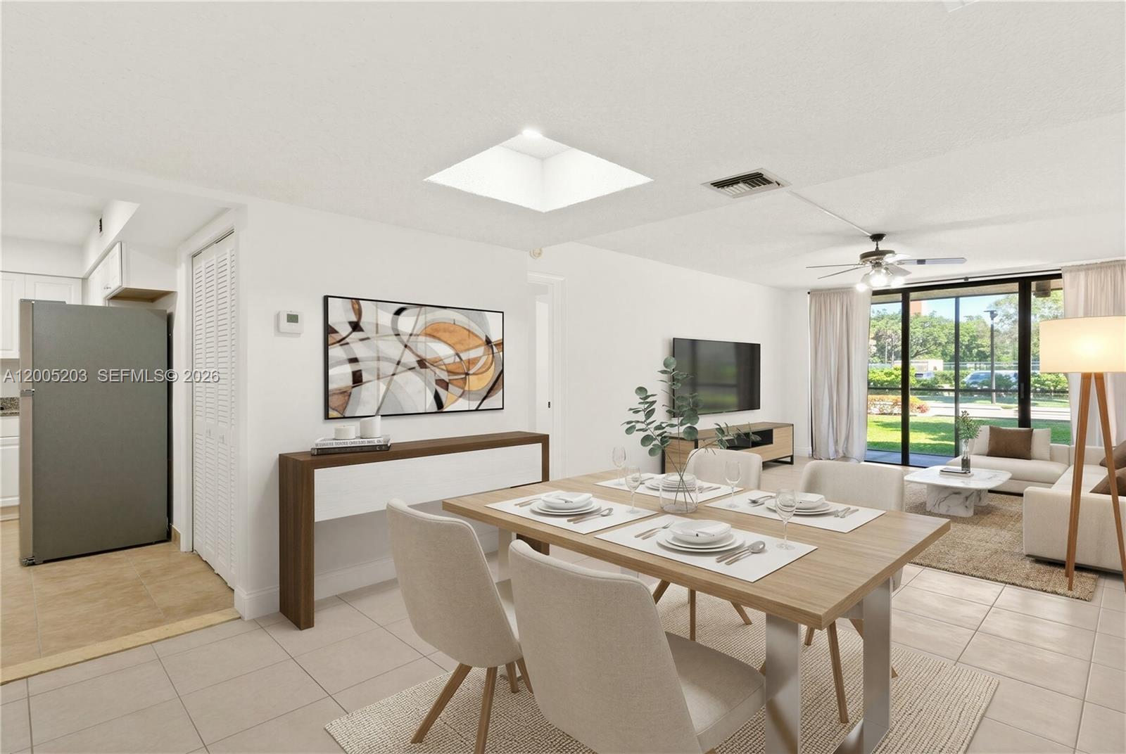 16400 Golf Club Road, Unit 104 Weston, FL 33326 - Photo 12 of 34 a living room with furniture a flat screen tv and a table