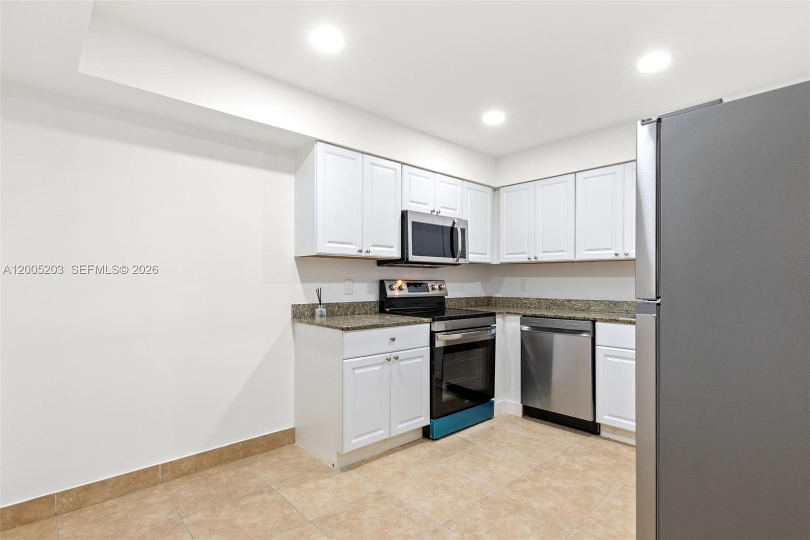 16400 Golf Club Road, Unit 104 Weston, FL 33326 - Photo 15 of 34 a kitchen with a refrigerator stove and microwave