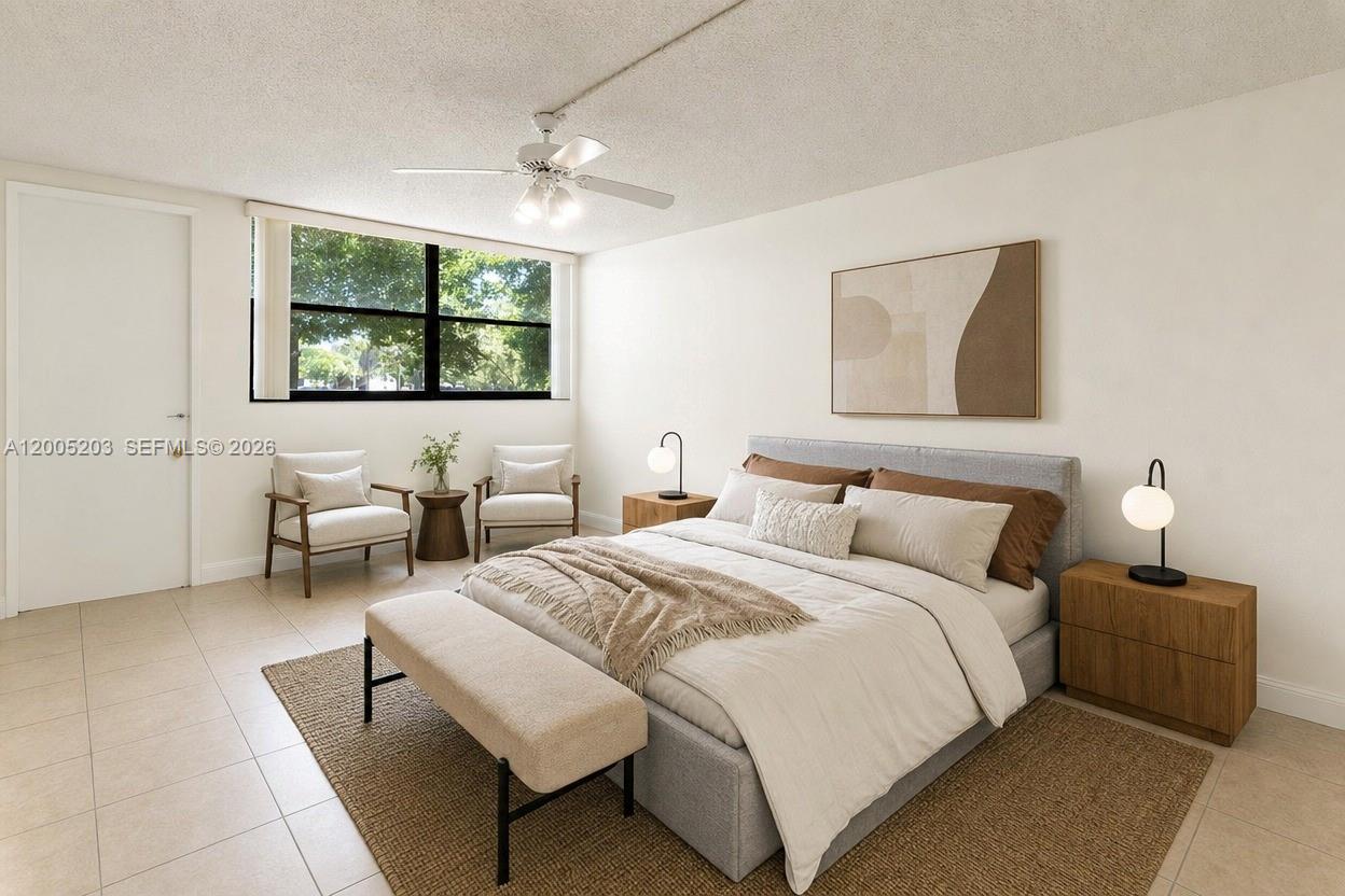 16400 Golf Club Road, Unit 104 Weston, FL 33326 - Photo 19 of 34 a bedroom with a bed and glass wall