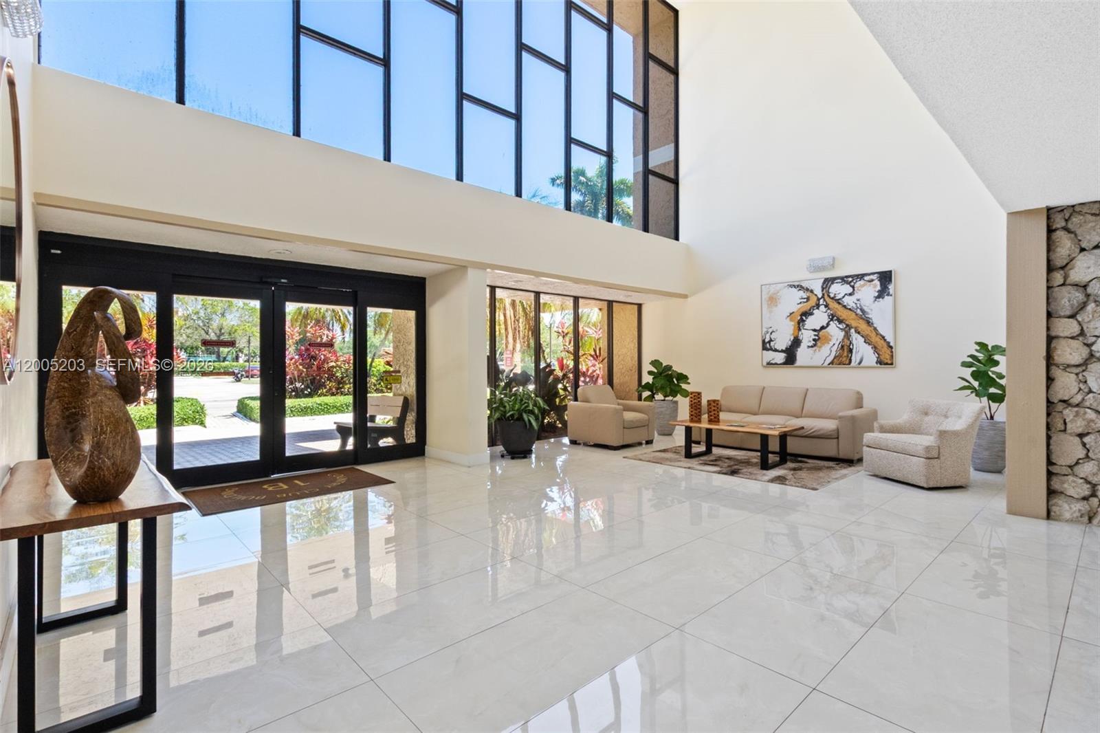 16400 Golf Club Road, Unit 104 Weston, FL 33326 - Photo 2 of 34 a living room with furniture and large windows