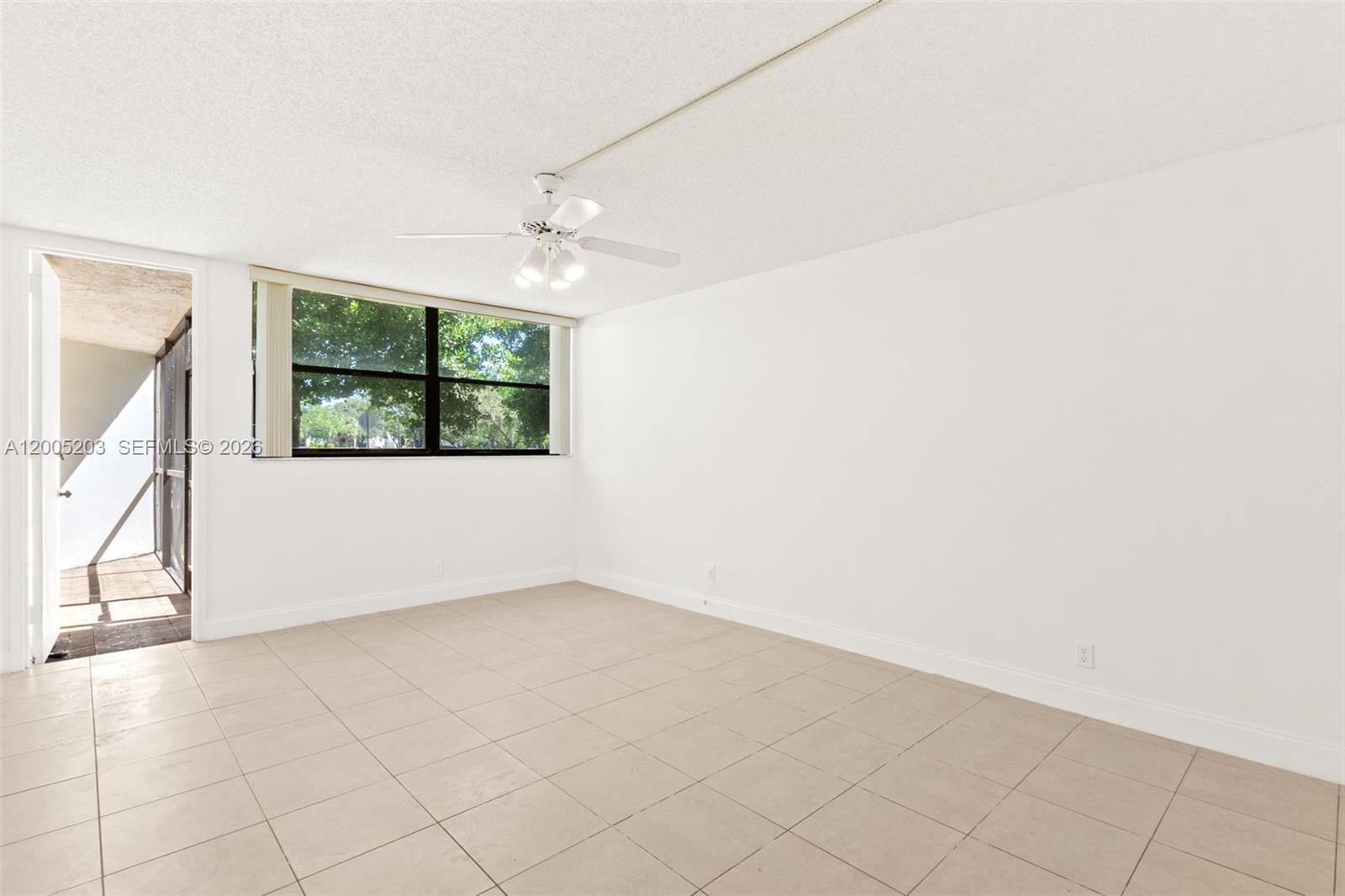 16400 Golf Club Road, Unit 104 Weston, FL 33326 - Photo 23 of 34 an empty room with windows and fan