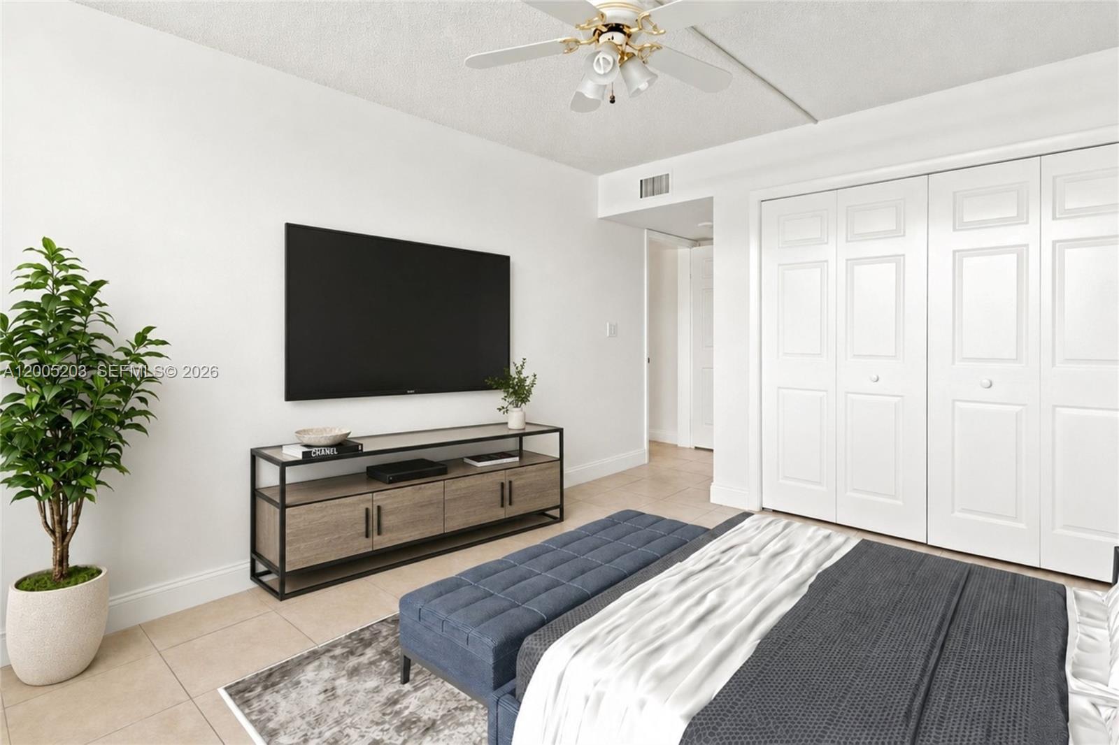 16400 Golf Club Road, Unit 104 Weston, FL 33326 - Photo 26 of 34 a bedroom with a bed and a flat screen tv
