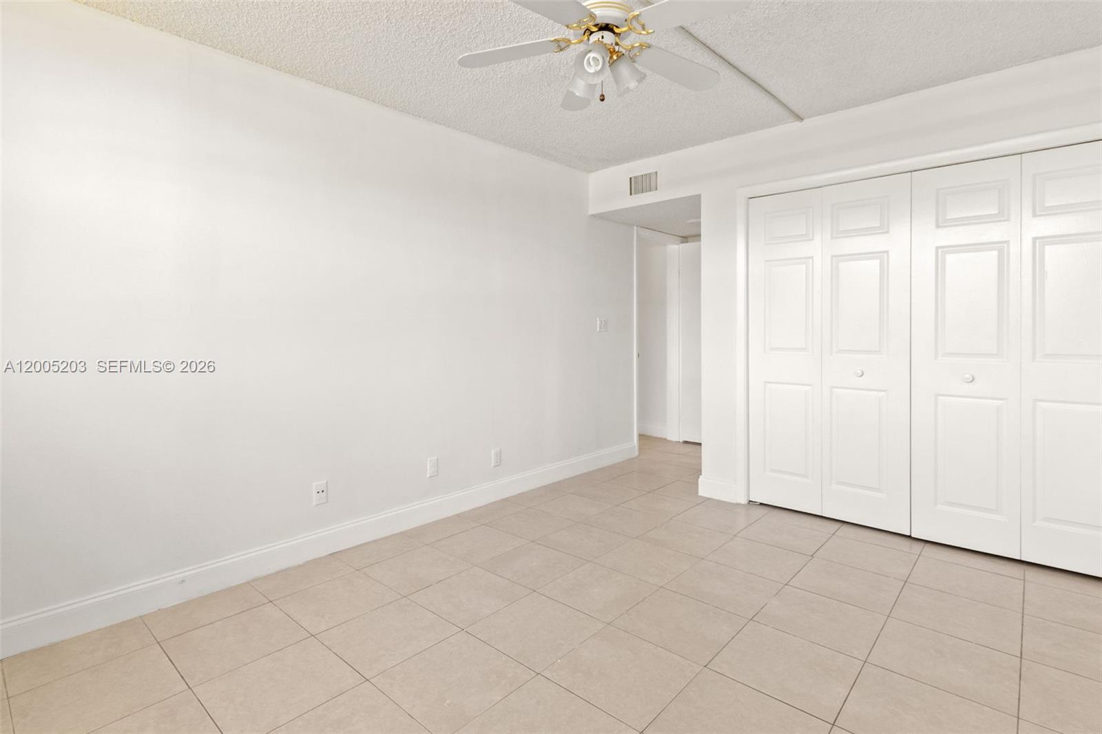 16400 Golf Club Road, Unit 104 Weston, FL 33326 - Photo 27 of 34 an empty room with a ceiling fan