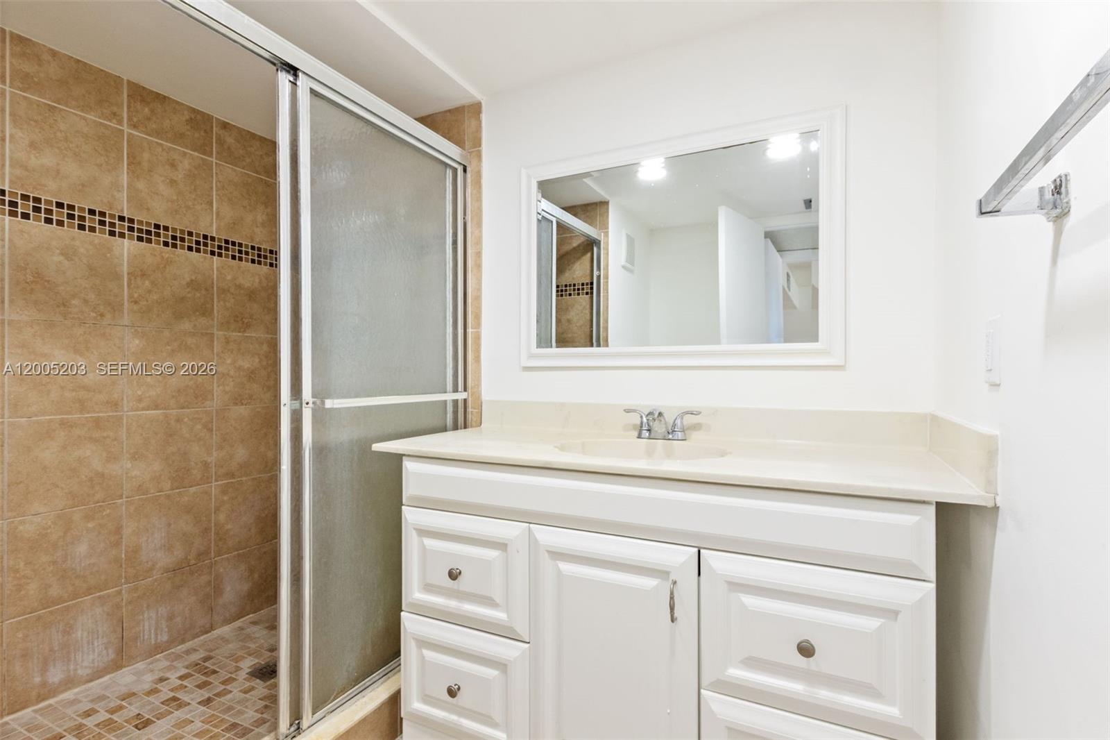 16400 Golf Club Road, Unit 104 Weston, FL 33326 - Photo 30 of 34 a bathroom with a sink and a mirror