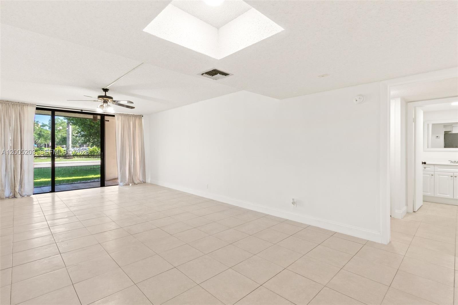 16400 Golf Club Road, Unit 104 Weston, FL 33326 - Photo 6 of 34 a view of an empty room with a window