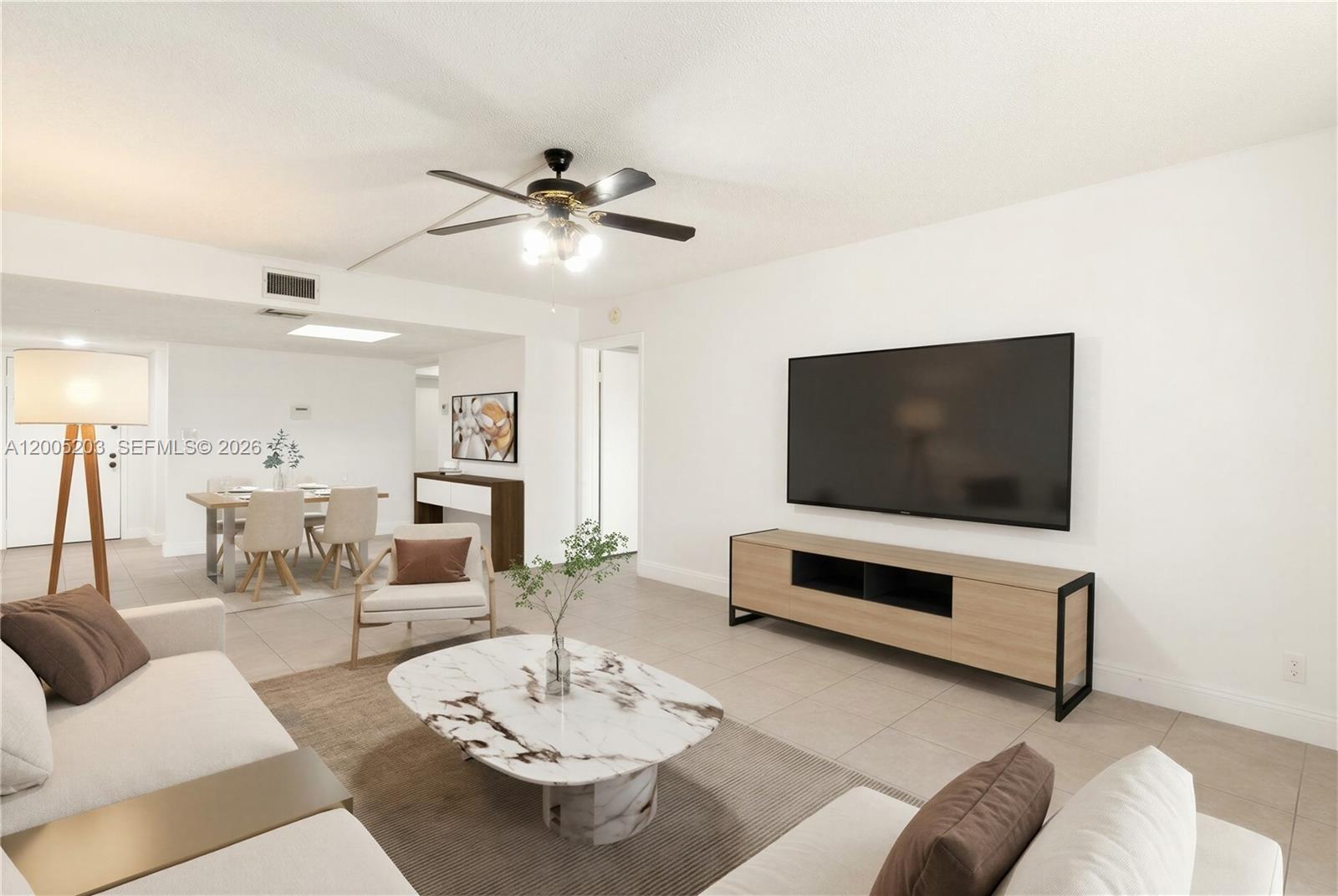16400 Golf Club Road, Unit 104 Weston, FL 33326 - Photo 9 of 34 a living room with furniture and a flat screen tv