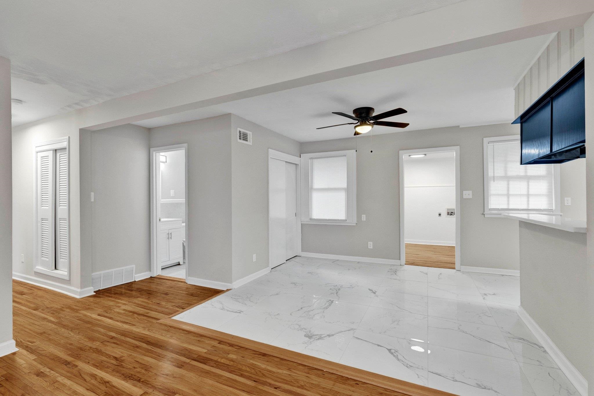 1866 Cherry Road Memphis, TN 38117 - Photo 4 of 20 a view of an empty room with wooden floor and a window
