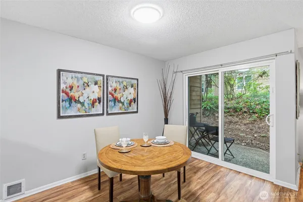 a view of a room with a table and chairs