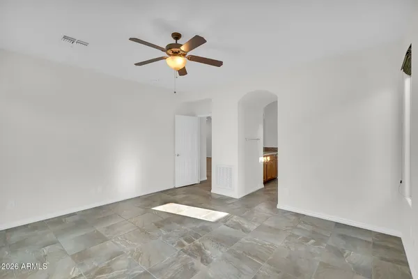 a view of a livingroom with a ceiling fan and window