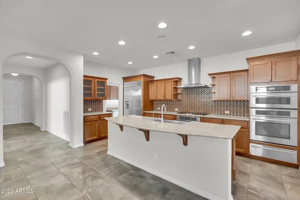a kitchen with stainless steel appliances granite countertop a refrigerator sink and cabinets