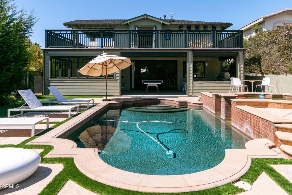 a swimming pool with outdoor seating yard and furniture