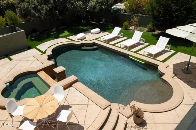 a living room with large window and a table