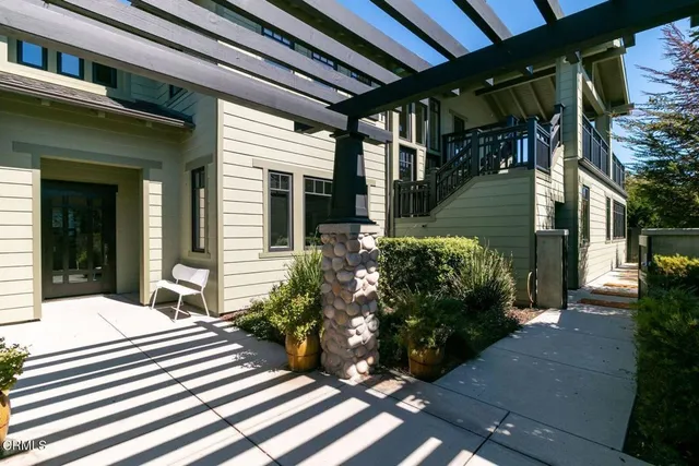 a kitchen with stainless steel appliances granite countertop a refrigerator a stove and a sink with large window