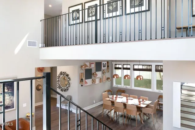 a front view of a house with potted plants