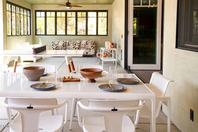 a kitchen with a table chairs and a wooden floor