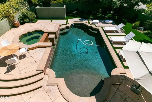 a balcony with table and chairs