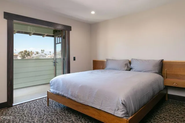 a kitchen with sink refrigerator dining table and chairs