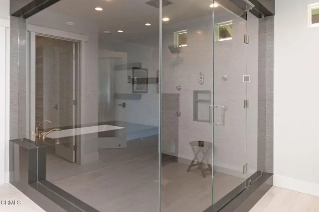 a kitchen with stainless steel appliances kitchen island granite countertop a stove and a sink