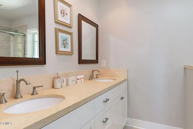 a kitchen with a table chairs sink and cabinets