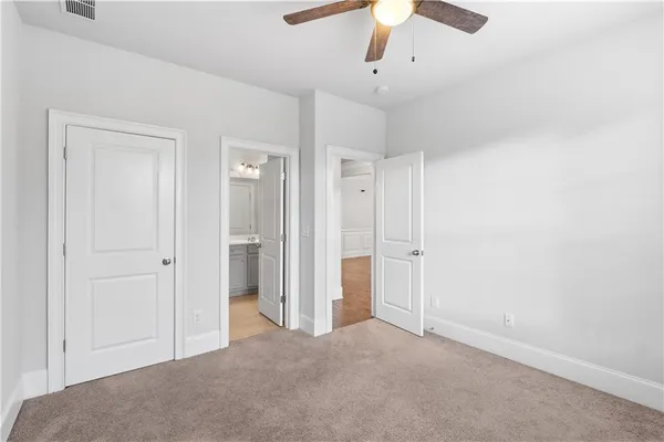 an empty room with chandelier fan