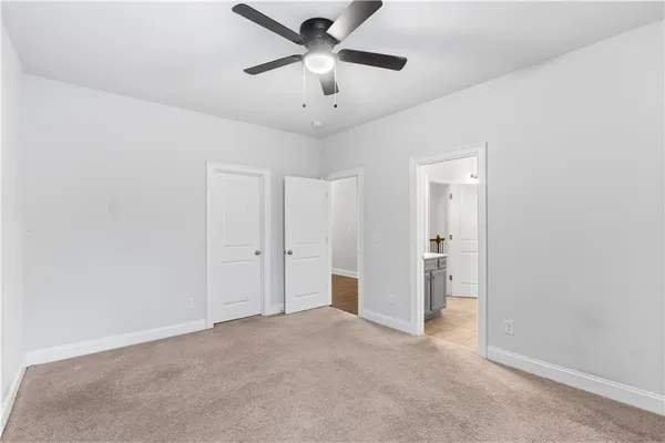 a view of a livingroom with a ceiling fan and window