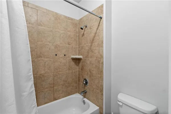 a bathroom with a shower and toilet