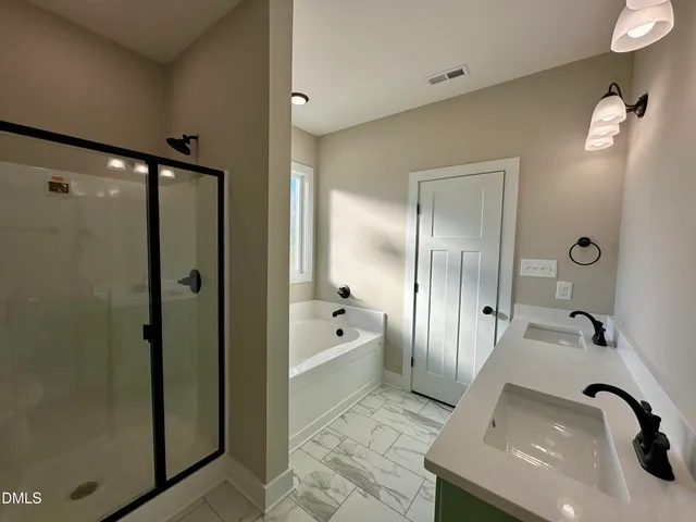 a bathroom with a bathtub and shower