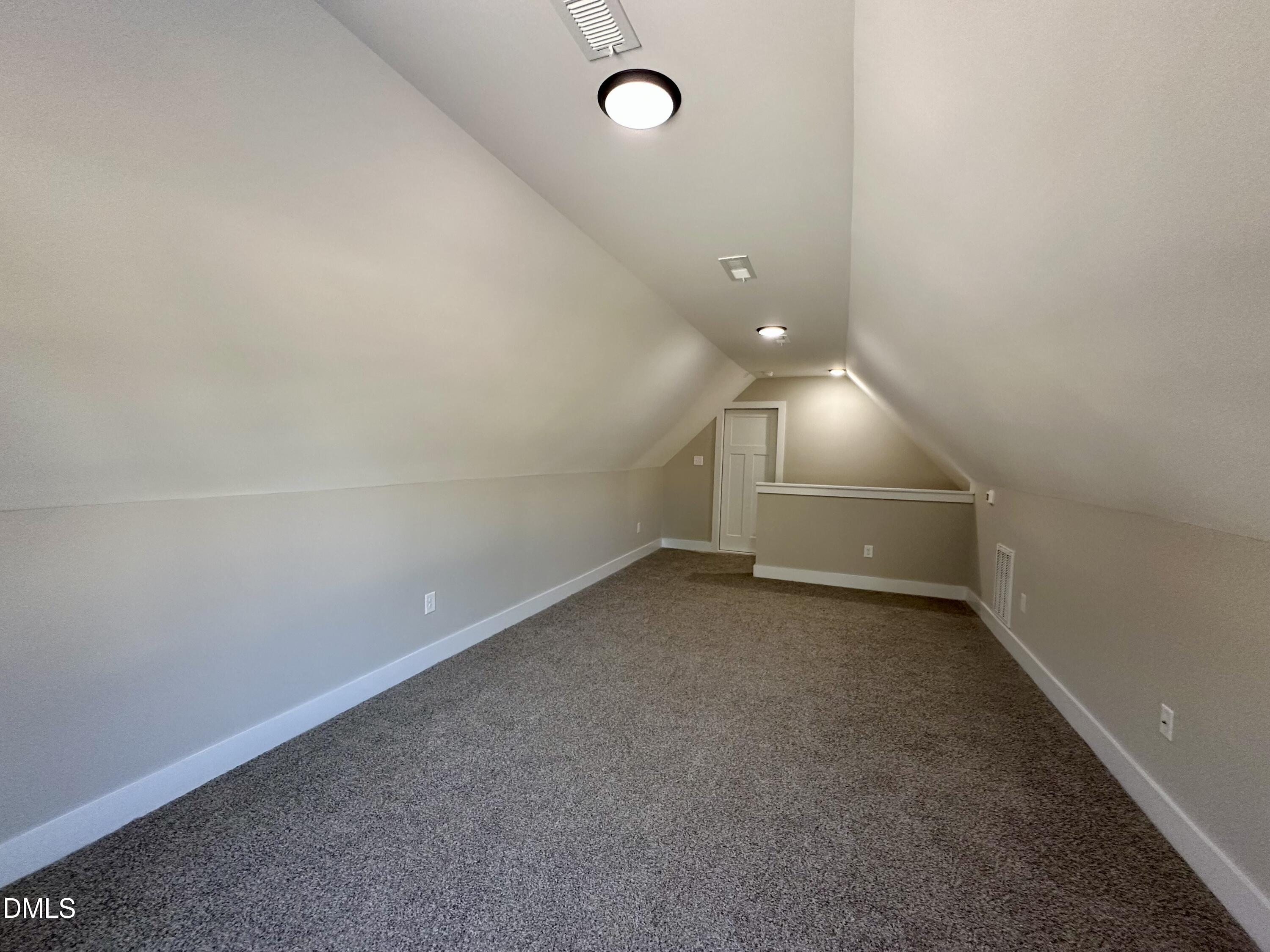 165 Bay Valley Road Kenly, NC 27542 - Photo 20 of 23 an empty room with wooden floor and windows