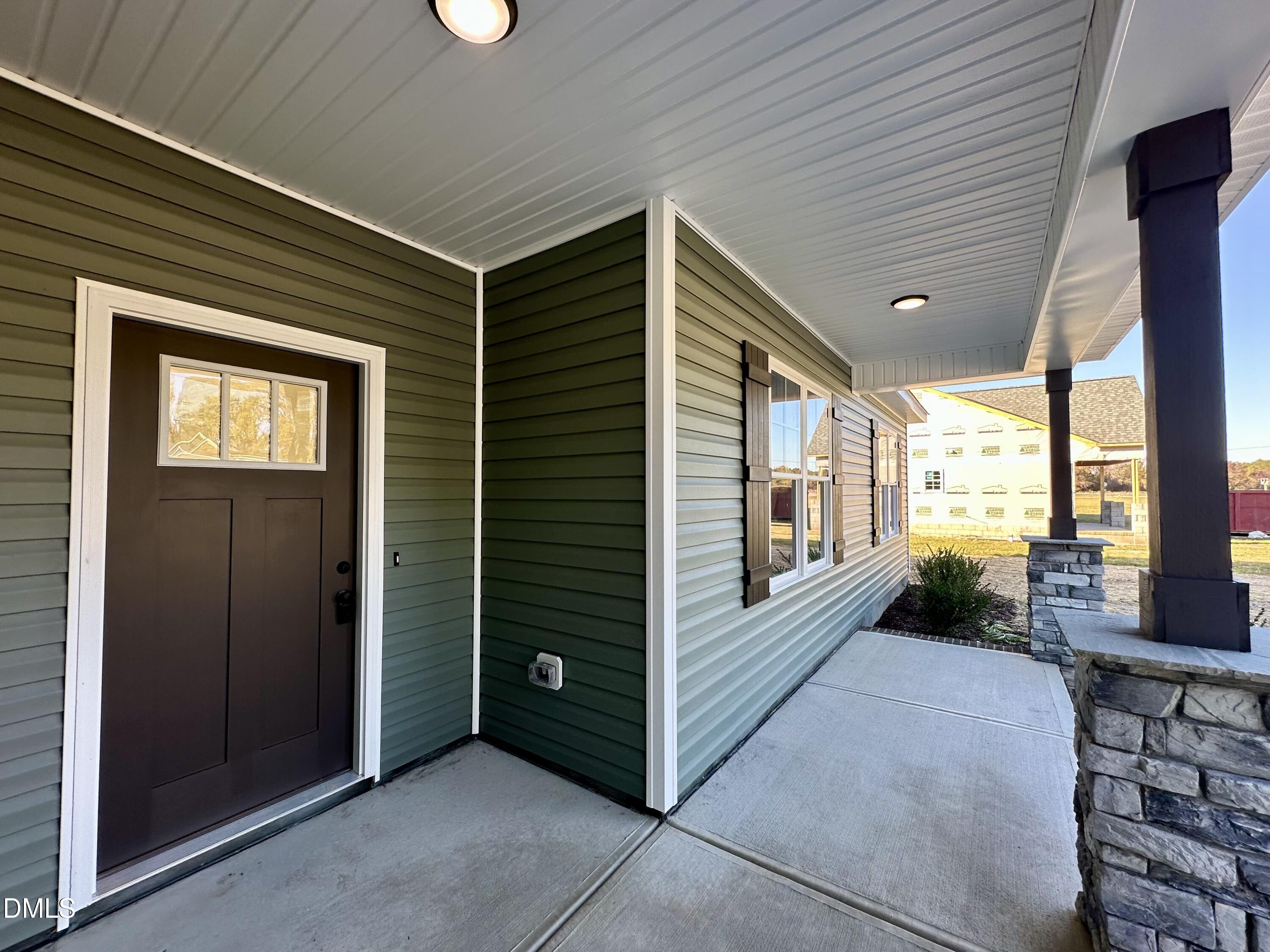 165 Bay Valley Road Kenly, NC 27542 - Photo 3 of 23 a view of a porch with furniture and floor to ceiling window